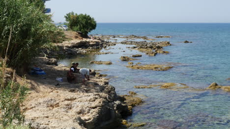 Greece-Crete-Aegean-Sea-Fishermen-On-Rocky-Ledge